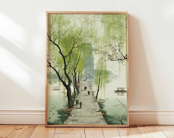 May include: A framed art print depicting a serene waterside scene. A stone path leads through weeping willow trees with vibrant green foliage. Figures stroll along the path, and small boats dot the water. The artwork is framed in a light wood.