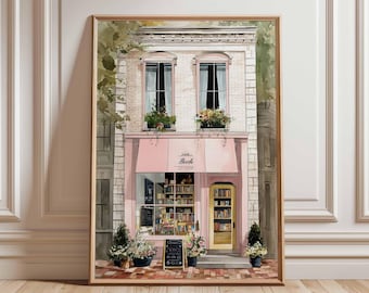 May include: A framed watercolor print of a quaint bookstore with a pink awning and a yellow door. The store's facade is white brick, with two windows above the awning. The print includes the text "Book Retreive" on the awning.
