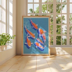 May include: A framed print showing koi carp swimming in a blue tiled pond. The fish are orange and white. The artwork is displayed in a room with natural light from a large window, with a wooden frame.