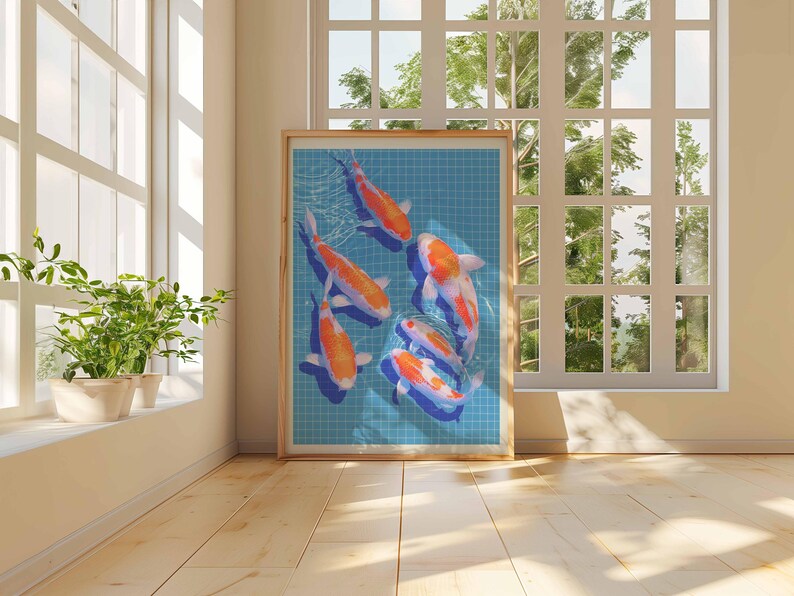 May include: A framed print showing koi carp swimming in a blue tiled pond. The fish are orange and white. The artwork is displayed in a room with natural light from a large window, with a wooden frame.