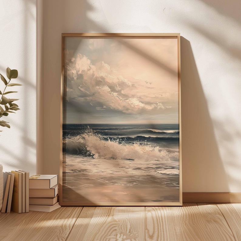 May include: A framed painting depicts a seascape with crashing waves and a cloudy sky. The artwork features shades of blue, white, and beige, creating a serene coastal scene. The wooden frame adds a classic touch to the artwork.