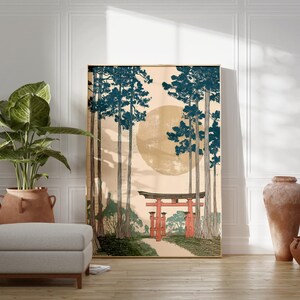 May include: A framed art print depicting a Japanese landscape with tall trees, a large sun, and a red torii gate. The artwork has a vintage aesthetic, with a neutral color palette and a touch of blue and red.