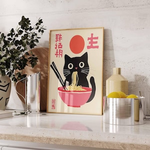May include: A black cat with a red circle and Japanese characters on a white background. The cat is eating noodles from a pink bowl. The text on the poster reads "Fresh Noodles" and "Life".