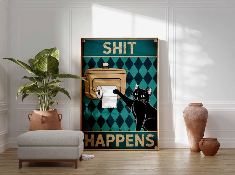 May include: A framed poster with the words "SHIT HAPPENS" and a black cat reaching for toilet paper. The background features a teal diamond pattern. A tan toilet paper dispenser is also visible.