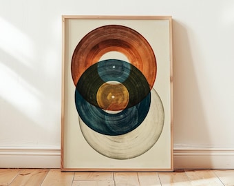 Puede incluir: Una lámina de arte enmarcada que presenta una disposición vertical de cuatro formas circulares de discos de vinilo superpuestas en tonos naranja quemado, azul verdoso profundo, amarillo mostaza y blanco roto sobre un fondo crema.