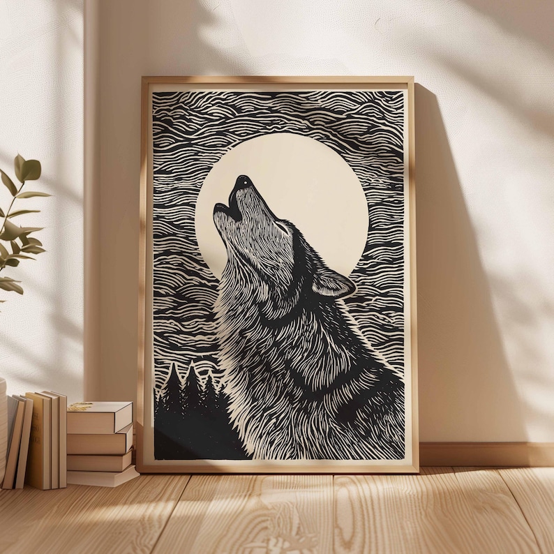 May include: A framed black and white art print depicting a howling wolf under a full moon. The woodcut-style artwork shows detailed lines for the wolf's fur and a textured sky. A forest silhouette is at the bottom of the print.