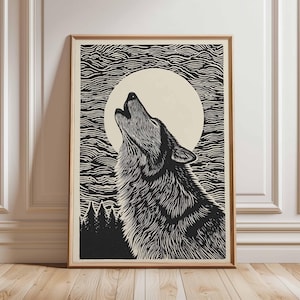May include: A framed black and white print depicting a howling wolf under a full moon. The artwork is in a detailed linocut style, with a textured finish. The background features stylized waves and a forest silhouette.