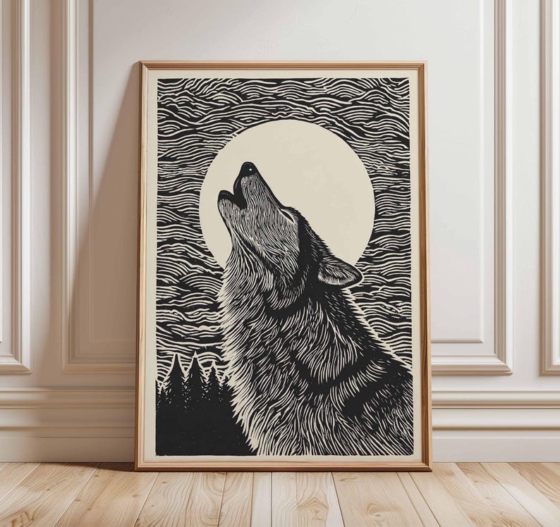 May include: A framed black and white print depicting a howling wolf under a full moon. The artwork is in a detailed linocut style, with a textured finish. The background features stylized waves and a forest silhouette.