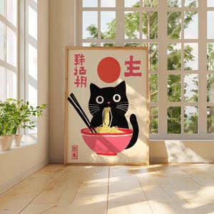 May include: A black cat with big eyes is eating ramen noodles from a pink bowl. The poster has Japanese characters that say "Ramen" and "Life".