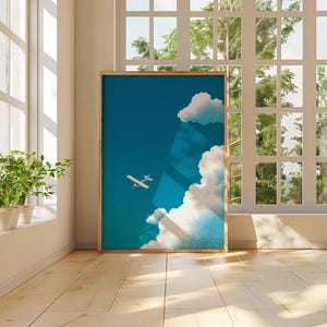 Peut inclure: Une affiche encadr&eacute;e repr&eacute;sentant un ciel bleu avec des nuages blancs et un petit avion blanc. L'&oelig;uvre est expos&eacute;e dans une pi&egrave;ce avec la lumi&egrave;re naturelle d'une grande fen&ecirc;tre et une plante en pot sur le rebord.