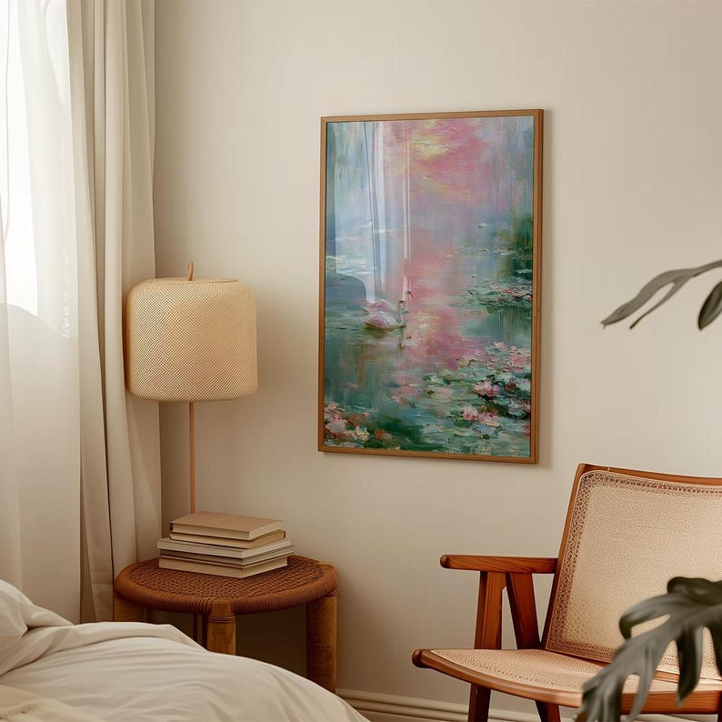 May include: A framed artwork depicting a serene water scene with pink and green hues. The painting features water lilies and a soft, impressionistic style. The artwork is displayed on a beige wall, adding a touch of elegance to the room.