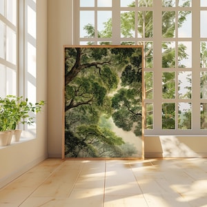 May include: A framed art print of a forest canopy in shades of green and brown. The artwork is displayed in a bright room with a large window overlooking a lush green landscape. Potted plants sit on the windowsill.
