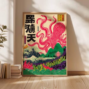 May include: A framed art print featuring a vibrant red octopus with long tentacles, set against a backdrop of Japanese-style mountains, waves, and a pagoda. The artwork includes Japanese characters and is framed in a natural wood tone.