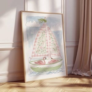 May include: Watercolor painting of a sailboat with a pink and white checkered sail, floral accents, and two pink flamingos. The boat is green and white, set against a blue sky with white clouds. The artwork is framed in a light wood frame.