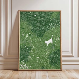 May include: A framed art print showing a green landscape with white line art. The artwork depicts a grassy field with various plants and a white cat. The print is in a wooden frame and is displayed on a wooden floor.