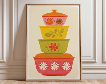 May include: A framed print depicting a stack of four colourful mixing bowls with lids. The bowls are in shades of orange, pink, yellow, and green, with floral and leaf designs. The artwork has a retro, vintage aesthetic.