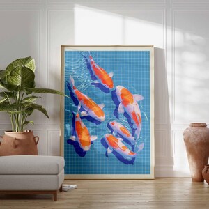 May include: A framed art print depicting koi carp swimming in a blue pond with a grid pattern. The fish are orange and white. The artwork is displayed in a room with a plant, ottoman, and decorative vases. The print is in a room.
