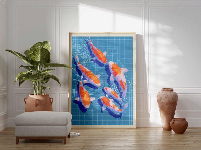 May include: A framed art print depicting koi carp swimming in a blue pond with a grid pattern. The fish are orange and white. The artwork is displayed in a room with a plant, ottoman, and decorative vases. The print is in a room.
