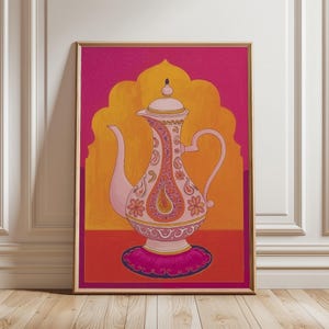 May include: Framed print of a decorative teapot in pink and orange, adorned with paisley and floral designs. The artwork has a vibrant pink and orange background, set within a gold frame.