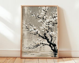May include: A framed art print featuring a black and white painting of a flowering tree. The tree's dark trunk and branches contrast with the white blossoms against a textured, neutral background. The artwork is in a light wood frame.