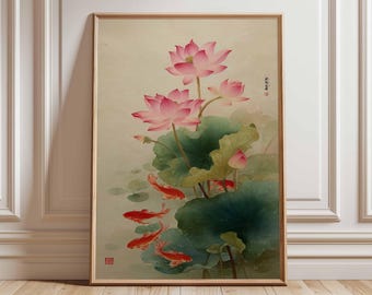 May include: A framed art print featuring a traditional Asian-style painting. The artwork depicts pink lotus flowers, green lily pads, and several orange koi fish swimming in a pond. The print has a light beige background and is framed in a light brown wood.