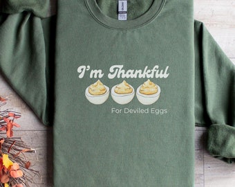 May include: A green sweatshirt with the text "I'm Thankful for Deviled Eggs" and a graphic of three deviled eggs.