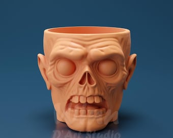 Könnte beinhalten: Ein pfirsichfarbener Zombie-Blumentopf mit detailliertem Schädeldesign. Der Topf hat hohle Augenhöhlen, eine markante Nase und einen offenen Mund, der Zähne zeigt. Der Text "D'Art Studio" ist unten aufgedruckt.