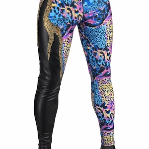 May include: Leggings featuring a split design with one side in solid black and the other in a vibrant blue, purple, and yellow animal print. A vertical panel of gold-toned embellishments separates the two sections along the upper thigh area.