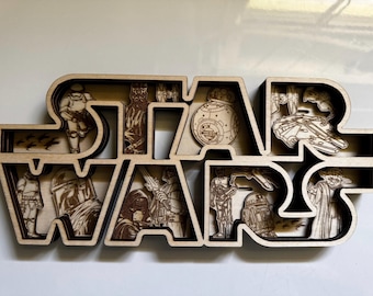 May include: A wooden wall decor featuring the Star Wars logo with various characters and spaceships from the franchise. The logo is made of layered wood and has a 3D effect.