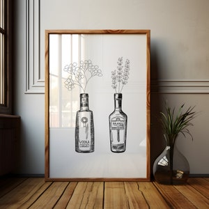 May include: A framed black and white illustration of two bottles with flowers in them. The bottle on the left says "Vodka Gold" and the bottle on the right says "Brandy VSOP".