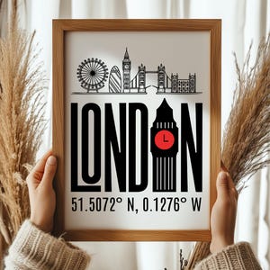 May include: A framed print with a black and white illustration of the London skyline, including Big Ben, the London Eye, and Tower Bridge. The text "LONDON" is in large, bold letters, with the coordinates "51.5072&deg; N, 0.1276&deg; W" below.