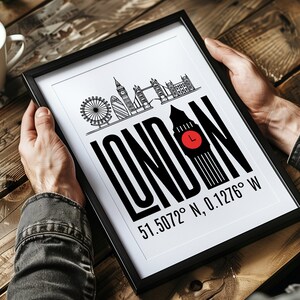 May include: A black and white framed print with a graphic design of the London skyline and the word "LONDON" in bold black letters. The Big Ben clock tower is featured prominently, with the text "51.5072&deg; N, 0.1276&deg; W" below.