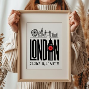 May include: A framed print with a black and white illustration of the London skyline, including Big Ben, the London Eye, and other iconic landmarks. The text "LONDON" is in bold black letters, and the coordinates "51.5072&deg; N, 0.1276&deg; W" are printed below the illustration.