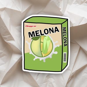 May include: A sticker featuring a cartoon illustration of a Melona ice cream bar. The design includes the brand name "Melona" in bold letters, a green and yellow melon slice, and a splash of white liquid.