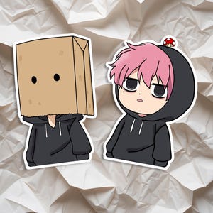 May include: Two stickers with cartoon characters. One has a brown paper bag over its head with black eyes, wearing a black hoodie. The other has pink hair, a mushroom on its head, and a black hoodie.