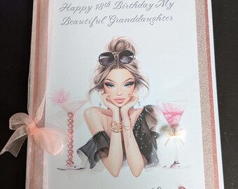 May include: A handmade birthday card with a glamorous illustration of a woman wearing sunglasses. The card reads "Happy 18th Birthday My Beautiful Granddaughter" and includes a pink ribbon and decorative embellishments. The card is framed with glittery borders.