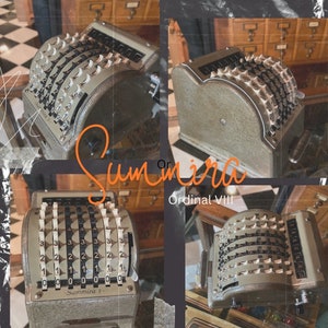 May include: A vintage mechanical calculator with a silver and gray finish. The calculator has a series of numbered dials and levers. The text "Summira 7" and "Ordinal VIII" are visible on the calculator.