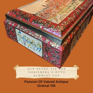 May include: A vintage red and gold tin box with a scene of a city on the lid. The box has the text "OLD RETRO TIN BOX NORINBERG E. OTTO SCHMIDT CAN" on the front. The text "Passion Of Valued Antique Ordinal VIII" is on the bottom of the image.