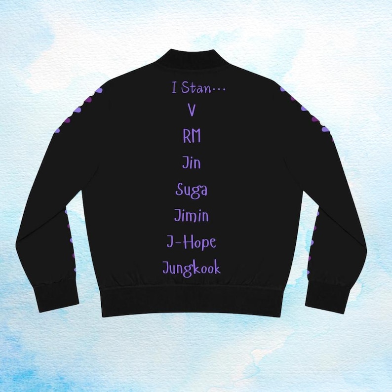 May include: Black bomber jacket with purple heart accents along the sleeves. The back of the jacket features the text "I Stan..." followed by a list of names in purple. A stylish and comfortable outerwear piece.