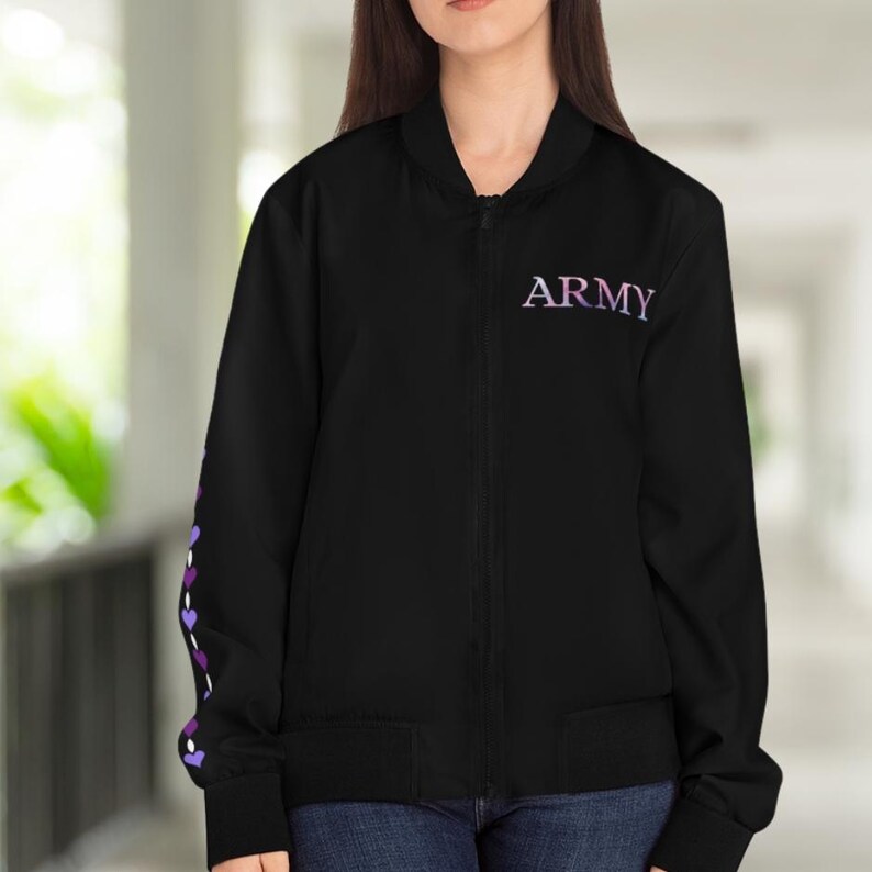 May include: Black bomber jacket with the word "ARMY" in purple and white lettering on the chest. The left sleeve features a design of purple and white hearts. The jacket has a zipper closure and two front pockets.