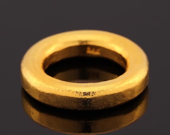 May include: A solid gold ring with a smooth, rounded surface. The ring is a simple, classic design.