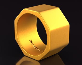 May include: A gold octagonal ring with a smooth, polished finish. The ring has a slightly rounded edge and is engraved with the text "Universal Work".
