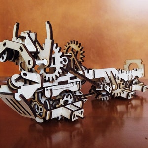 May include: A wooden model of a complex machine with gears, levers, and other moving parts. The model is made of natural wood and has a rustic, steampunk aesthetic.