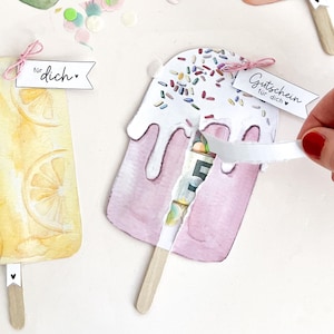 May include: DIY popsicle-shaped shaker cards with watercolor illustrations of lemon, watermelon, and strawberry flavors. The cards feature wooden sticks, small tags with text, and a slot for inserting money. Includes text: DIY SCHÜTTELKARTE EIS AM STIEL GUTSCHEIN GELDGESCHENK 4 DESIGNS PDF SOFORT DOWNLOAD.