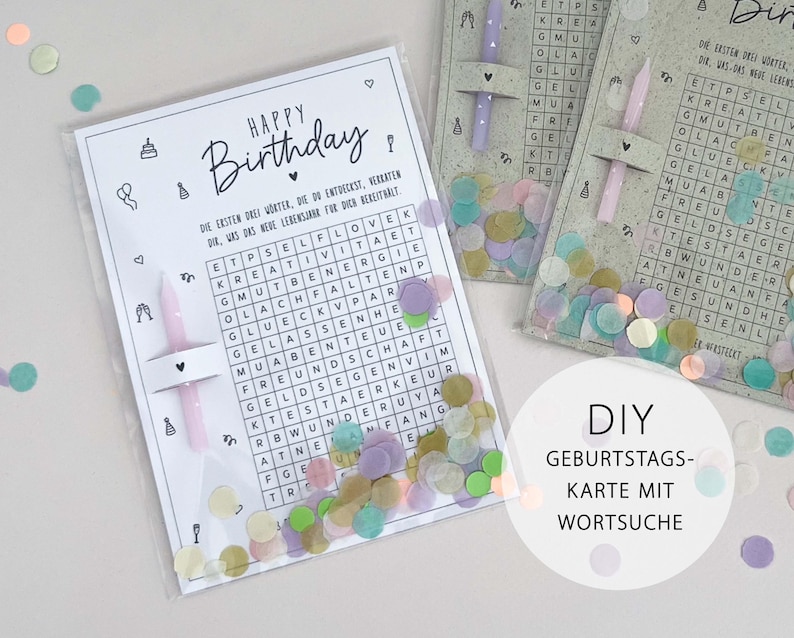 May include: A DIY birthday card with a word search puzzle, featuring the words "Happy Birthday" in elegant script. The card includes a pink candle and confetti. The text on the card is in German.