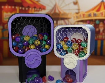 May include: Two colorful gumball machines with a carnival backdrop. The machines are purple and black, filled with multi-colored gumballs. The gumballs are scattered around the base of the machines. The machines have a honeycomb pattern on the front.