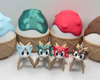 May include: Four whimsical ice cream cone-shaped containers with matching dragon-like figures. The containers have blue, green, red, and brown tops, with white and tan cone bases. The dragon figures have matching colors and are on wooden sticks.