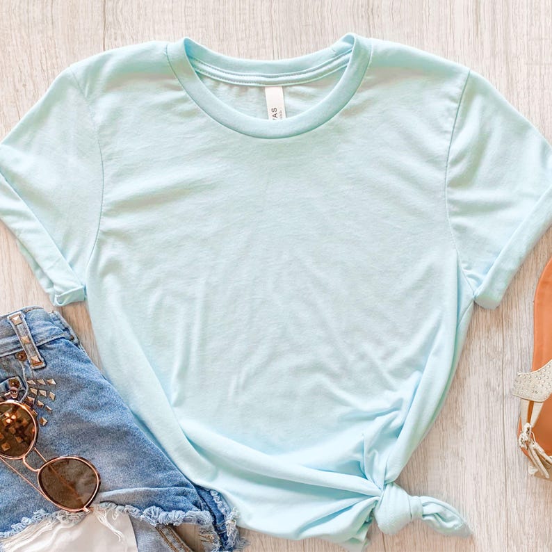 May include: A light blue t-shirt with a crew neck and short sleeves. The shirt is made of a soft, comfortable fabric and is perfect for everyday wear.