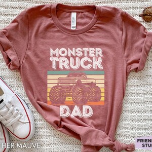 May include: Heather mauve t-shirt with a vintage-style graphic of a monster truck and the text "Monster Truck Dad".