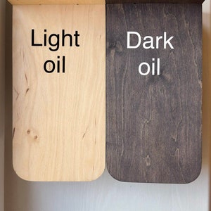 May include: Two wooden shelves, one finished with light oil and the other with dark oil. The shelves are both rectangular and have rounded edges. The text "Light oil" is written on the lighter shelf and "Dark oil" is written on the darker shelf.